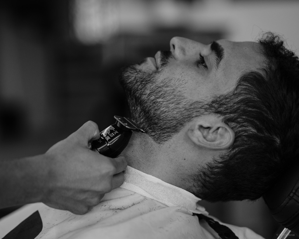 Beard grooming with a trimmer at a barber shop
